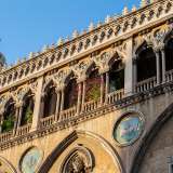 A Corradini si deve la creazione (assieme a Ettore Bernich) dello splendido edificio di corso Vittorio Emanuele. Un�opera che ancora oggi sorprende per l�intrigante facciata in stile neogotico veneziano ricca di richiami massonici, dettagli esoterici e stemmi misteriosi
